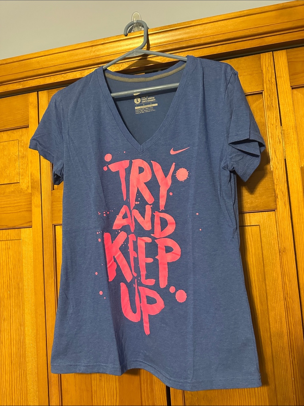NWOT Nike Women’s Blue V‑Neck Tee with Pink Graphic Slogan